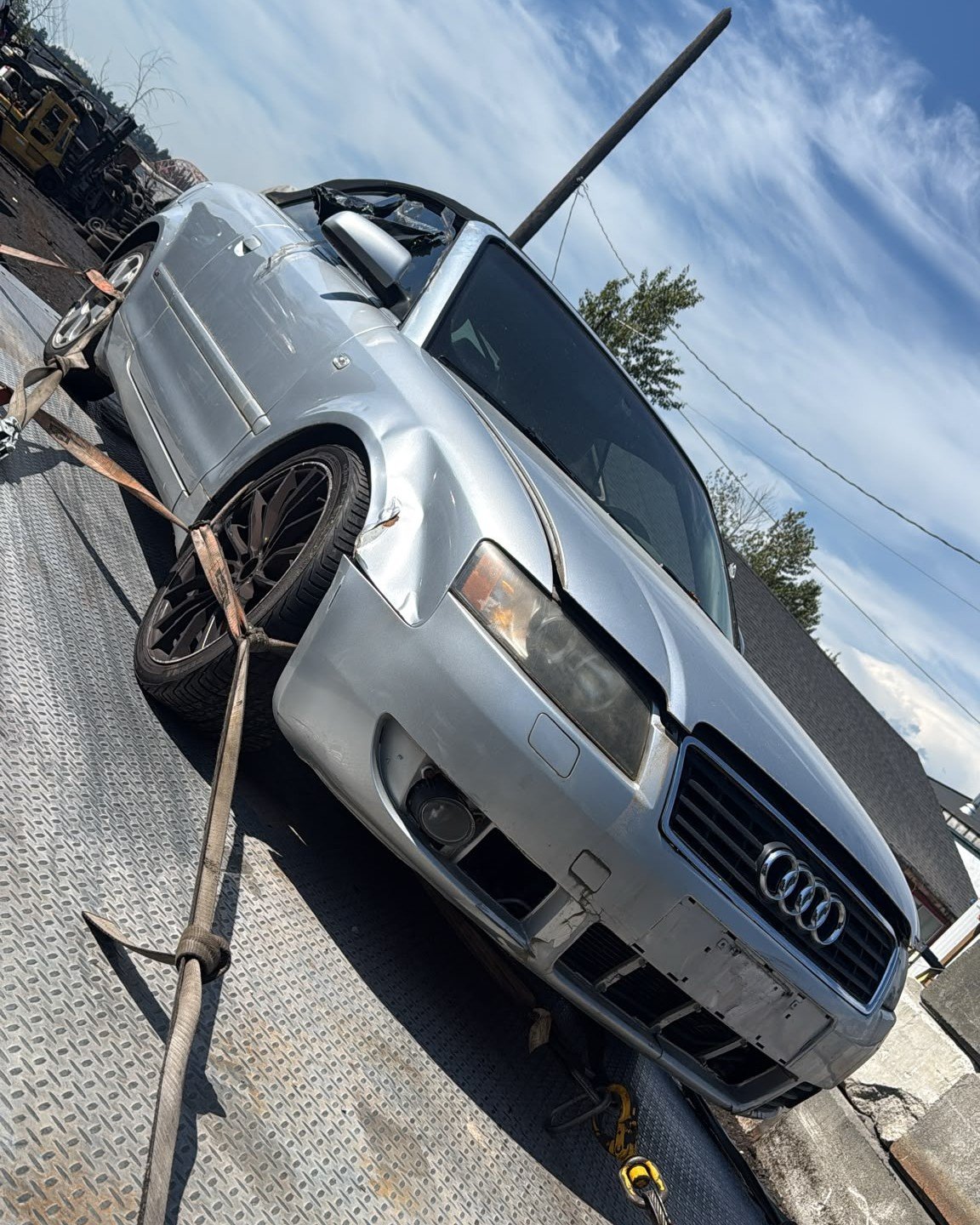 Scrap car being loaded onto our flatbed tow truck in Vancouver